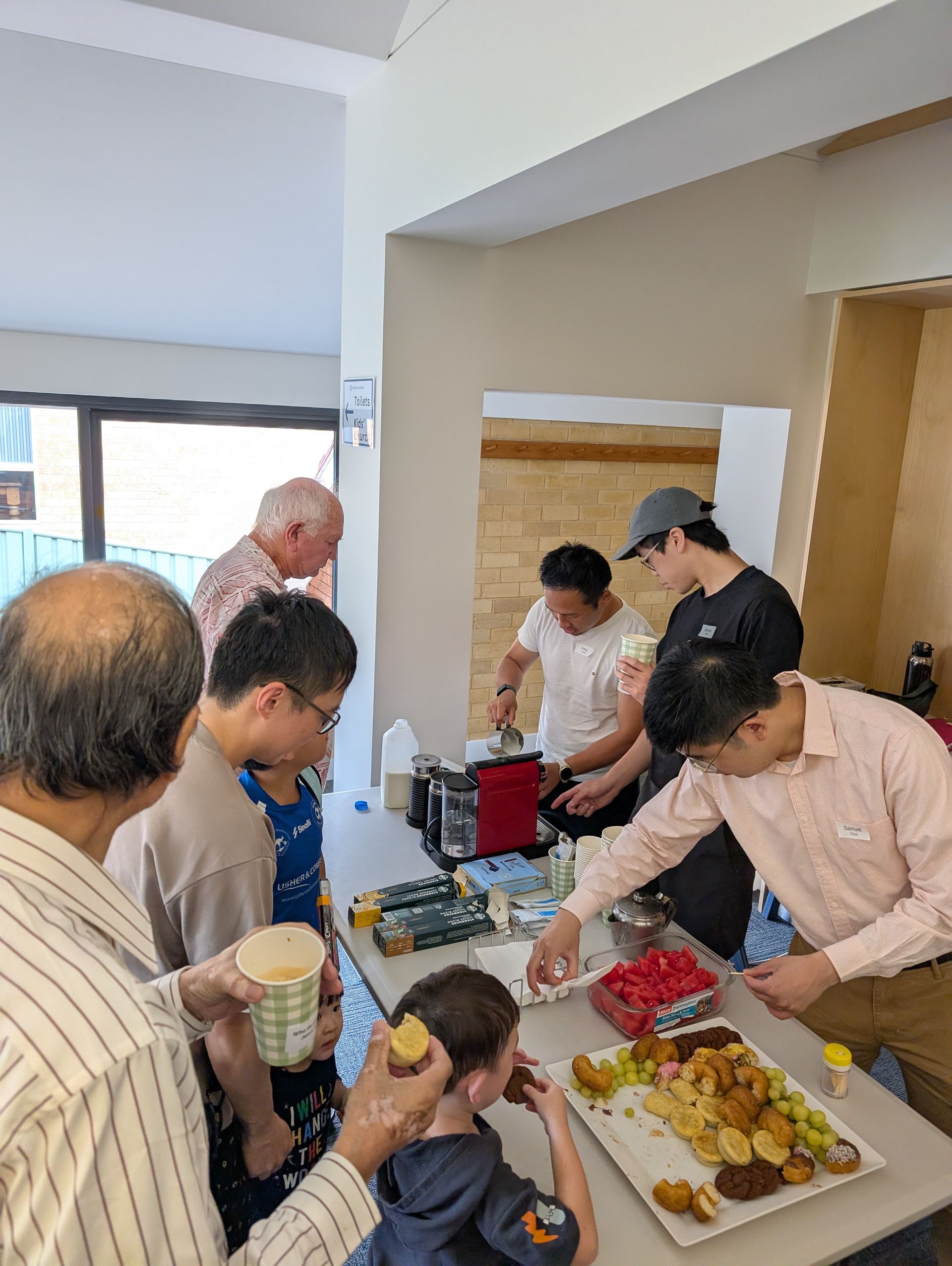 Church members gathering around the morning tea table