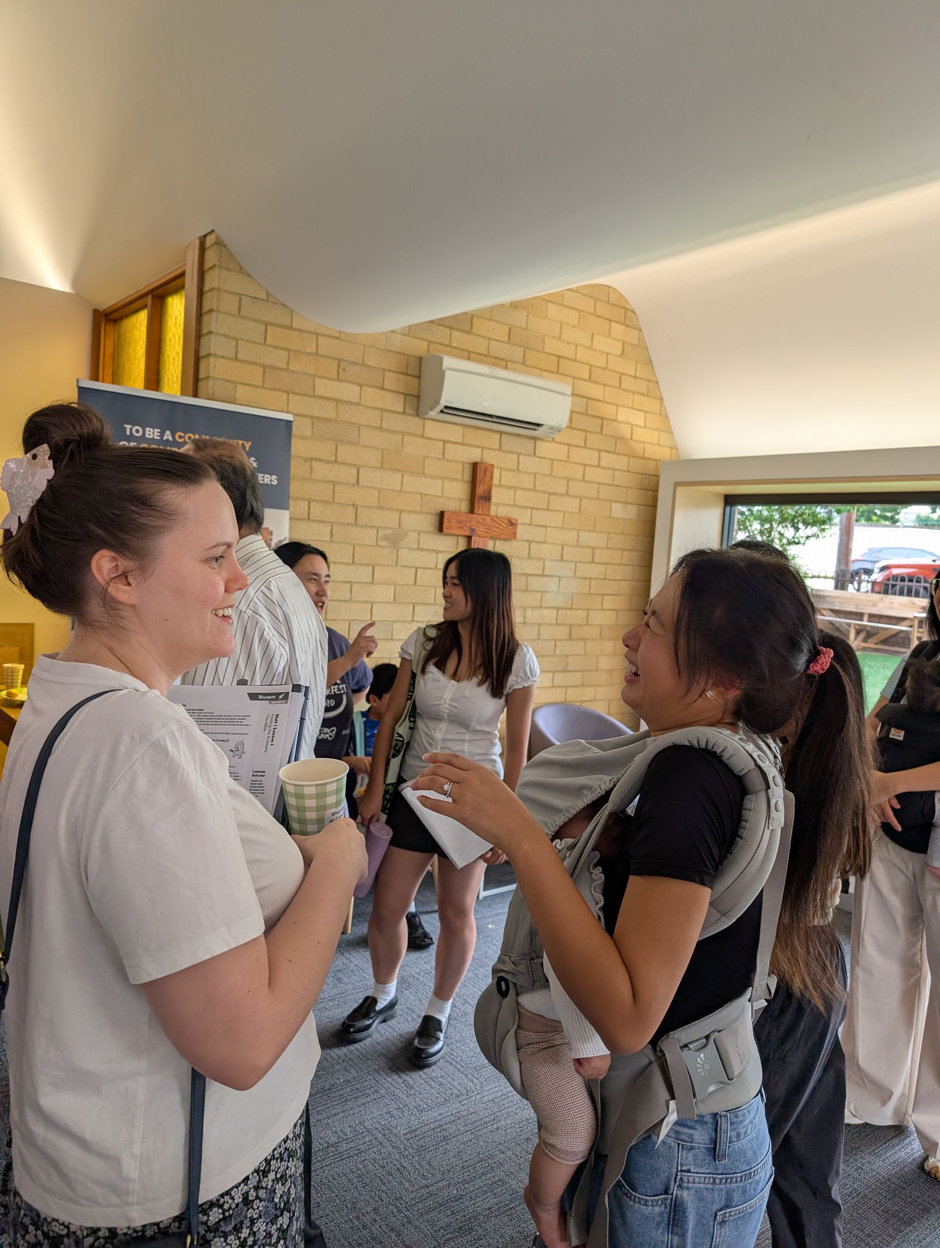 Young adults chatting and laughing near the cross